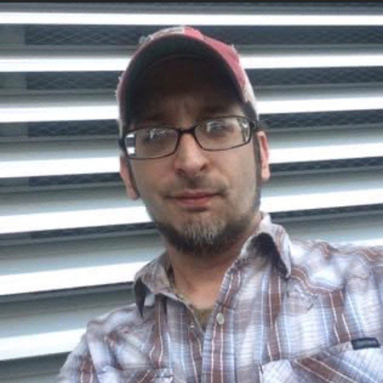 2_101554_19136706 A man wearing glasses and a hat.