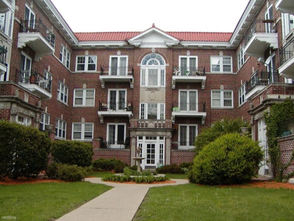 A large brick building with many windows and doors.